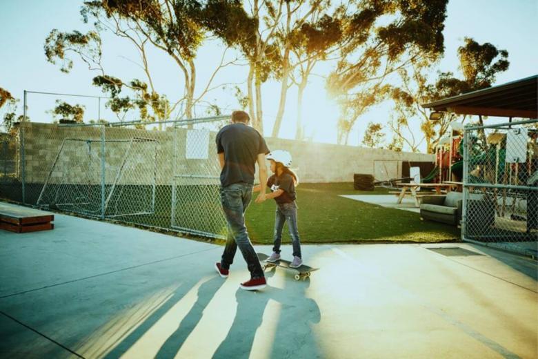 Image of Parent and Child Skateboarding